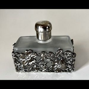 Perfume bottle with floral overlay. Empty.